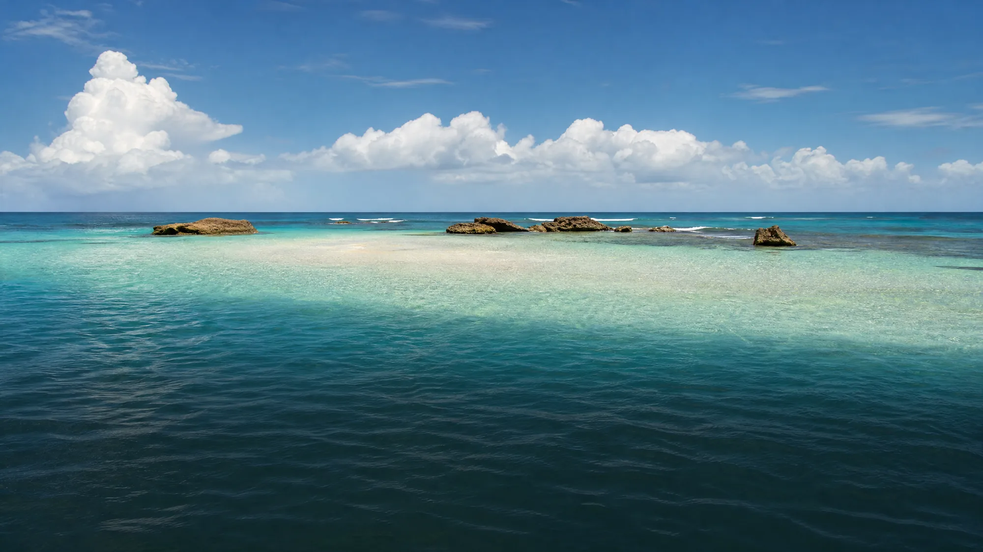 An offshore, waist-deep sandbar in the Caribbean Sea. It forms a natural wading pool within the protected Buccoo Reef Marine Park.